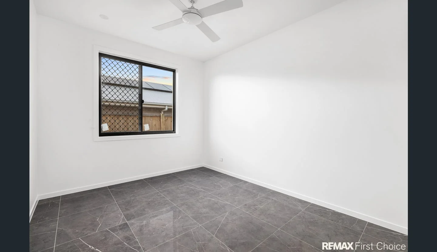 Light-filled bedroom with ceiling fan